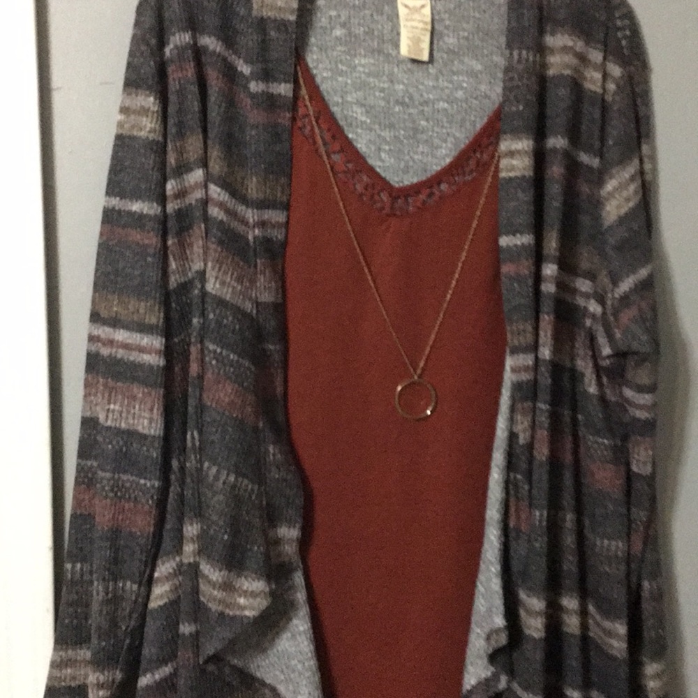 A dress shirt  with necklace attached to it